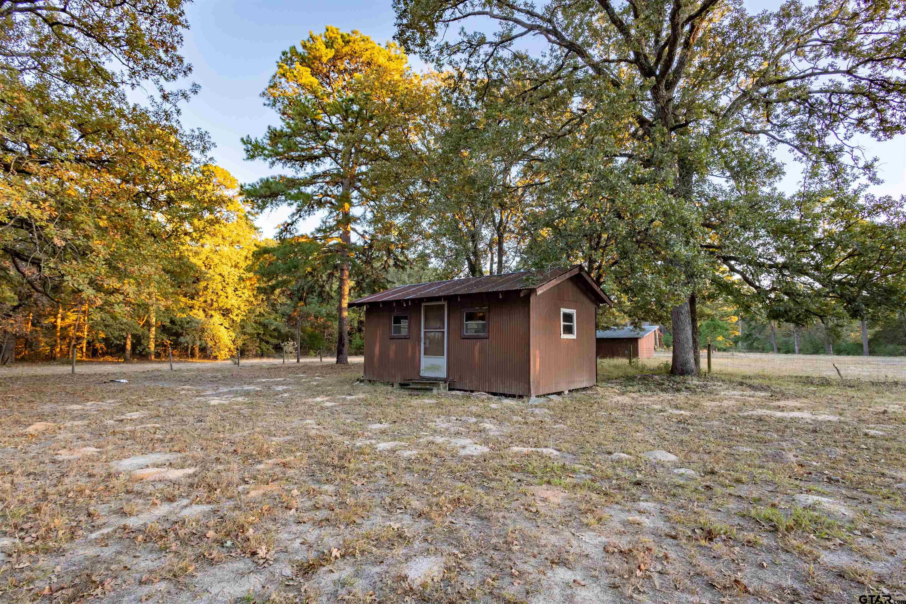3702 E Highway Quitman, TX 75783 - Photo 6 of 33 a big house with large trees and wooden fence