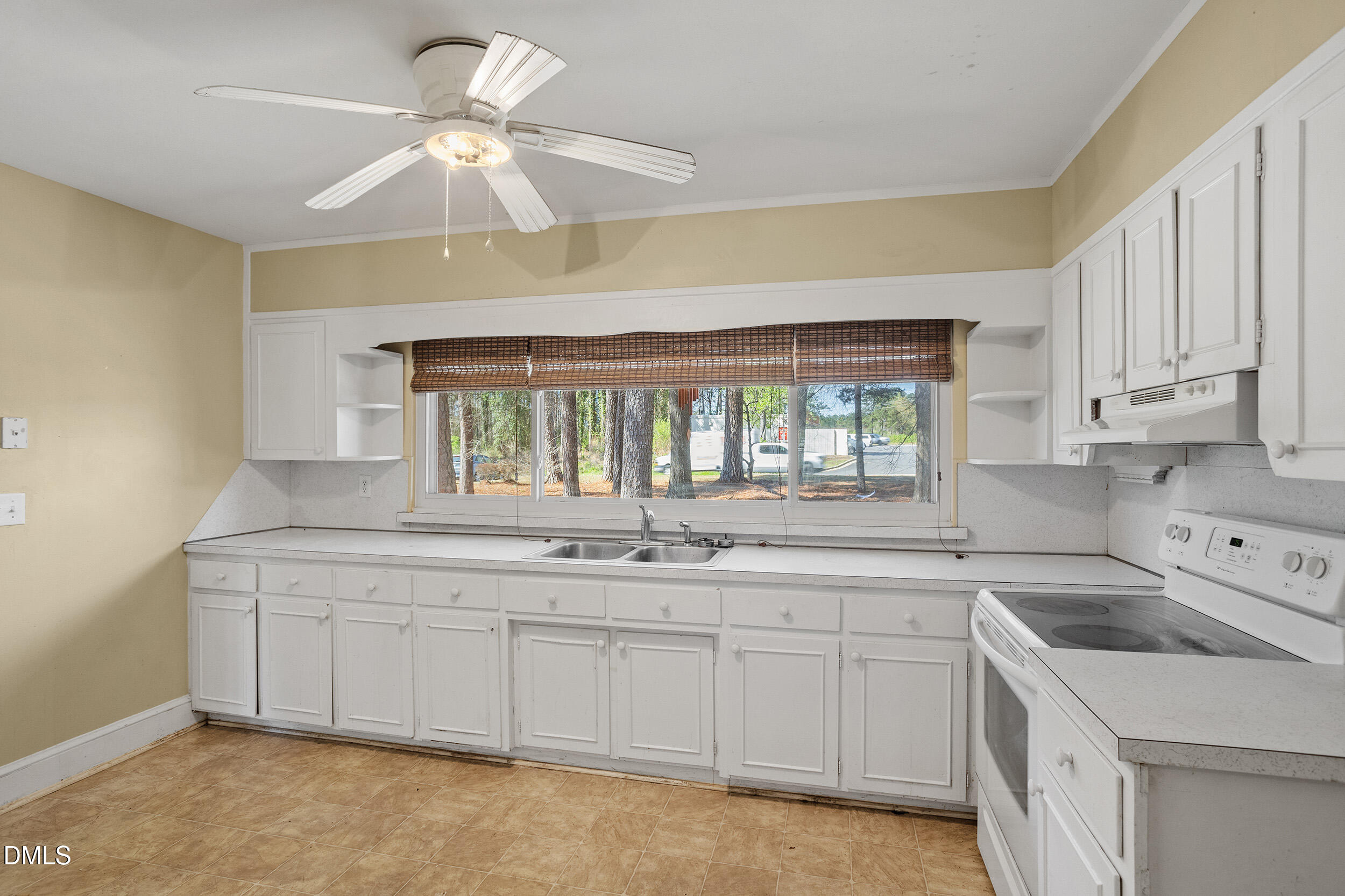 5011 Old Stage Road Raleigh, NC 27603 - Photo 15 of 29 a kitchen with a sink stove and cabinets