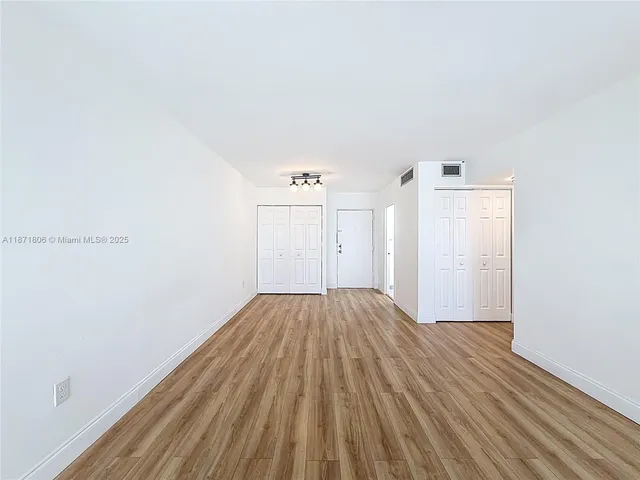 a view of kitchen with stainless steel appliances granite countertop refrigerator