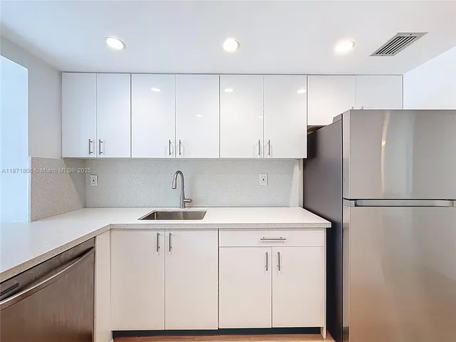 a bathroom with a toilet sink vanity and mirror