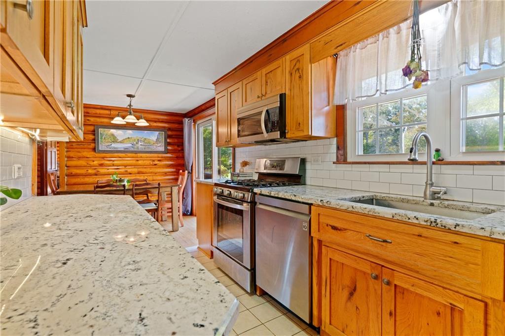 121 Jackson Street Harmony, PA 16037 - Photo 11 of 50 a kitchen with stainless steel appliances granite countertop a sink and cabinets