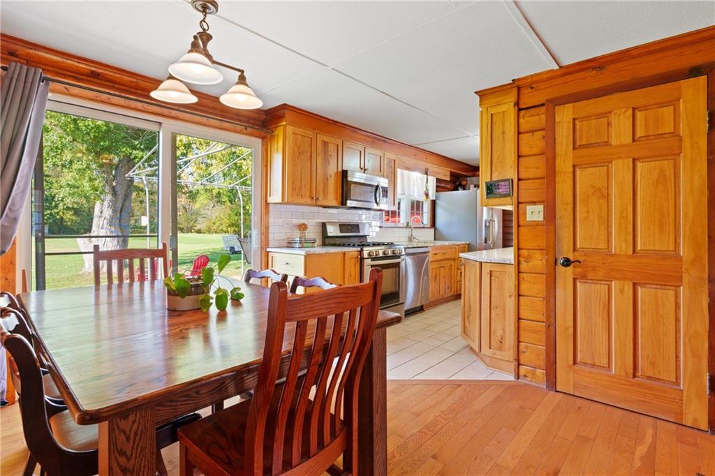121 Jackson Street Harmony, PA 16037 - Photo 13 of 50 a dining room with furniture a chandelier and wooden floor
