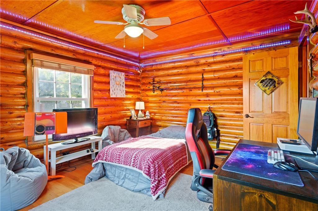 121 Jackson Street Harmony, PA 16037 - Photo 23 of 50 a bedroom with a bed and wooden floor