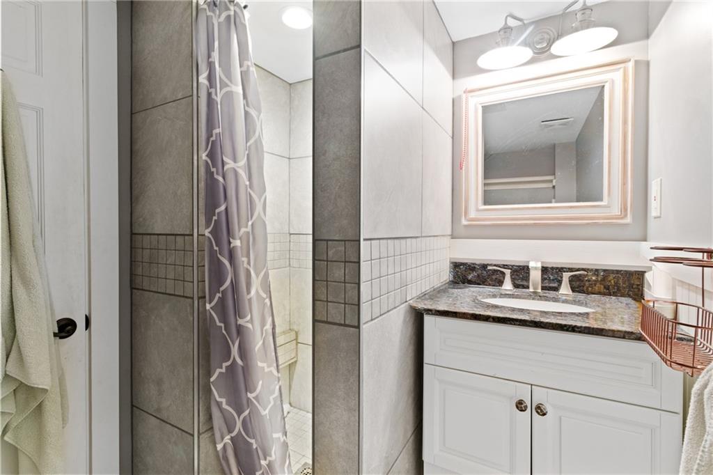 121 Jackson Street Harmony, PA 16037 - Photo 28 of 50 a bathroom with a sink vanity and a mirror