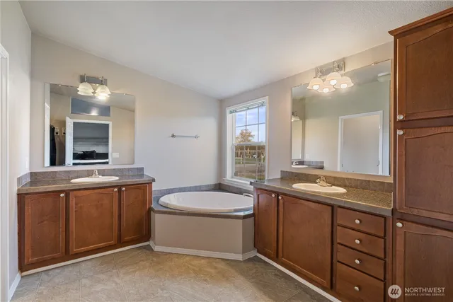 a bathroom with a granite countertop sink mirror and toilet