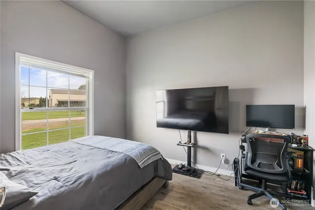 a bedroom with a bed and a flat screen tv