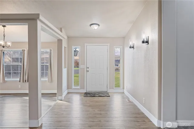 a view of an entryway with wooden floor
