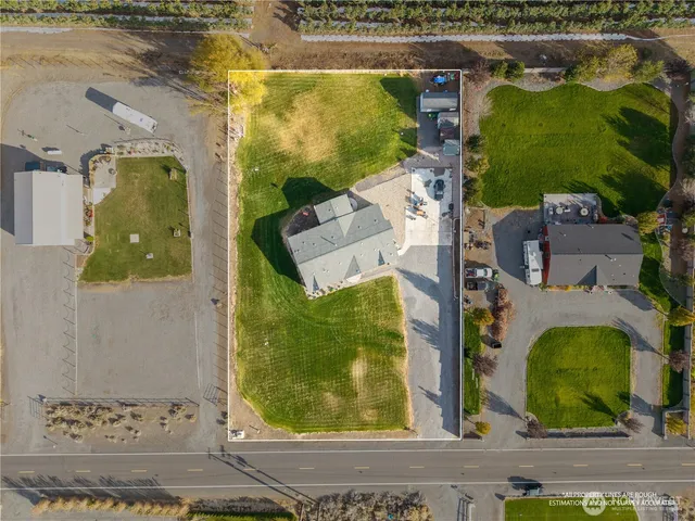 an aerial view of a residential houses with outdoor space