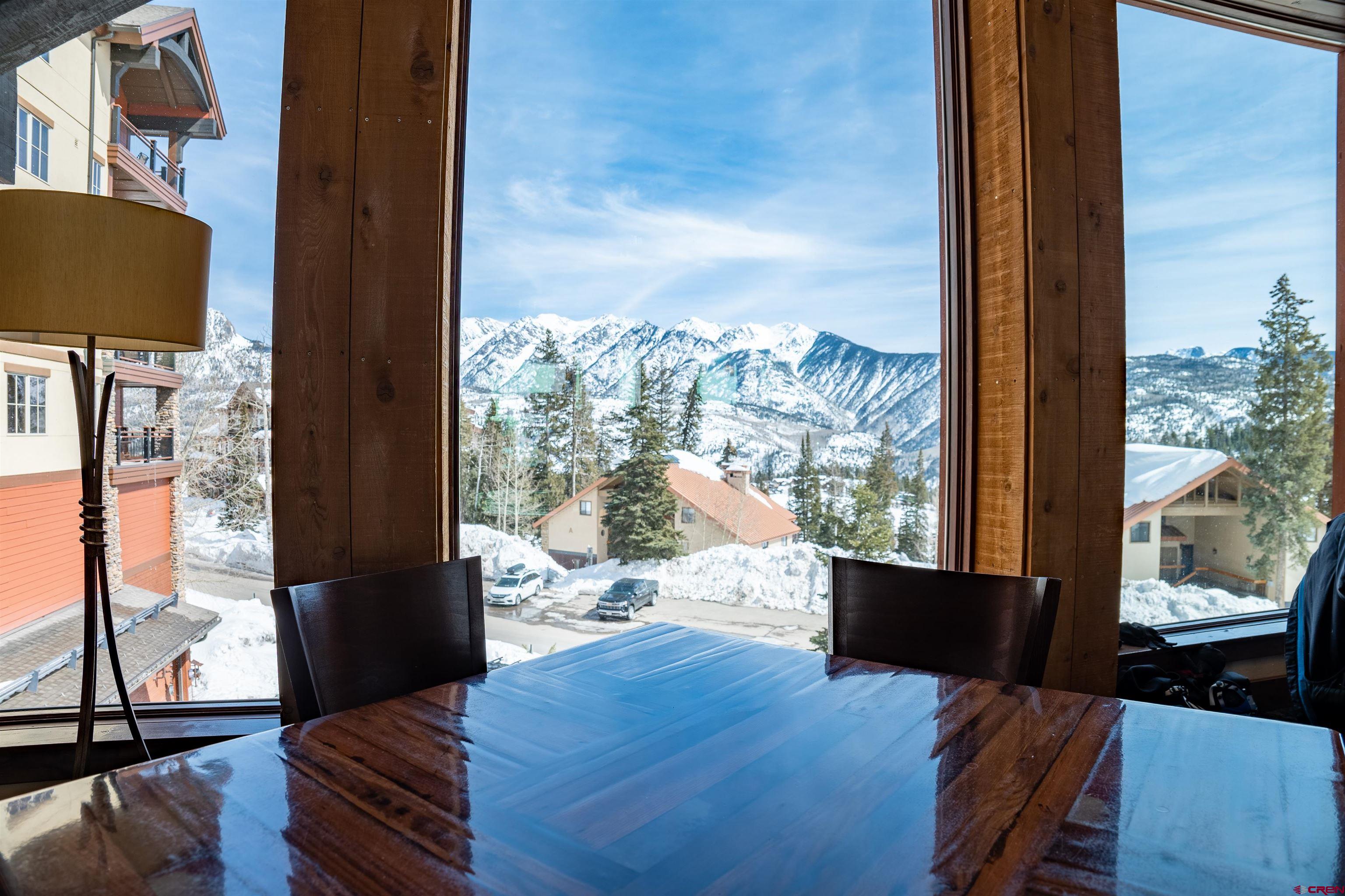 117 Needles Way, Unit 528 Durango, CO 81301 - Photo 13 of 41 a living room with couch floor to ceiling window and wooden floor