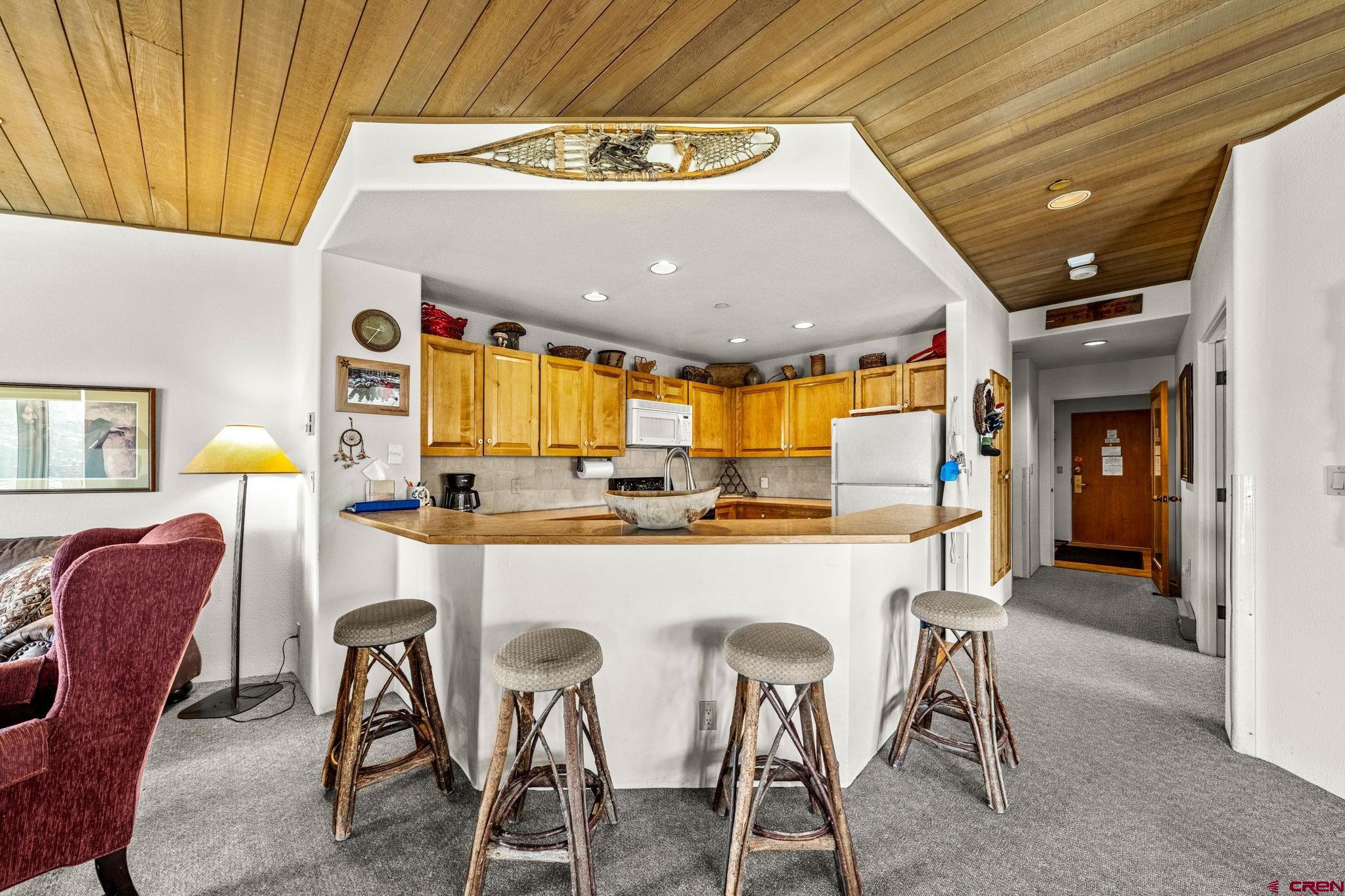 117 Needles Way, Unit 528 Durango, CO 81301 - Photo 16 of 41 a kitchen with a table and chairs in it