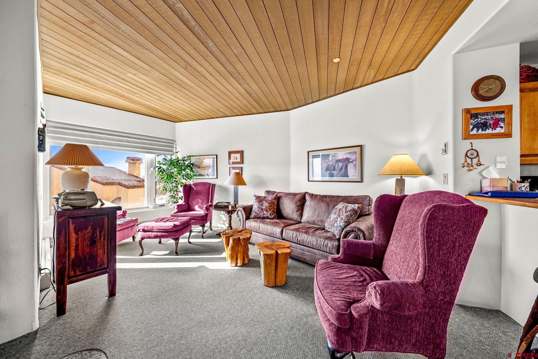 117 Needles Way, Unit 528 Durango, CO 81301 - Photo 19 of 41 a living room with furniture a window and bookshelf