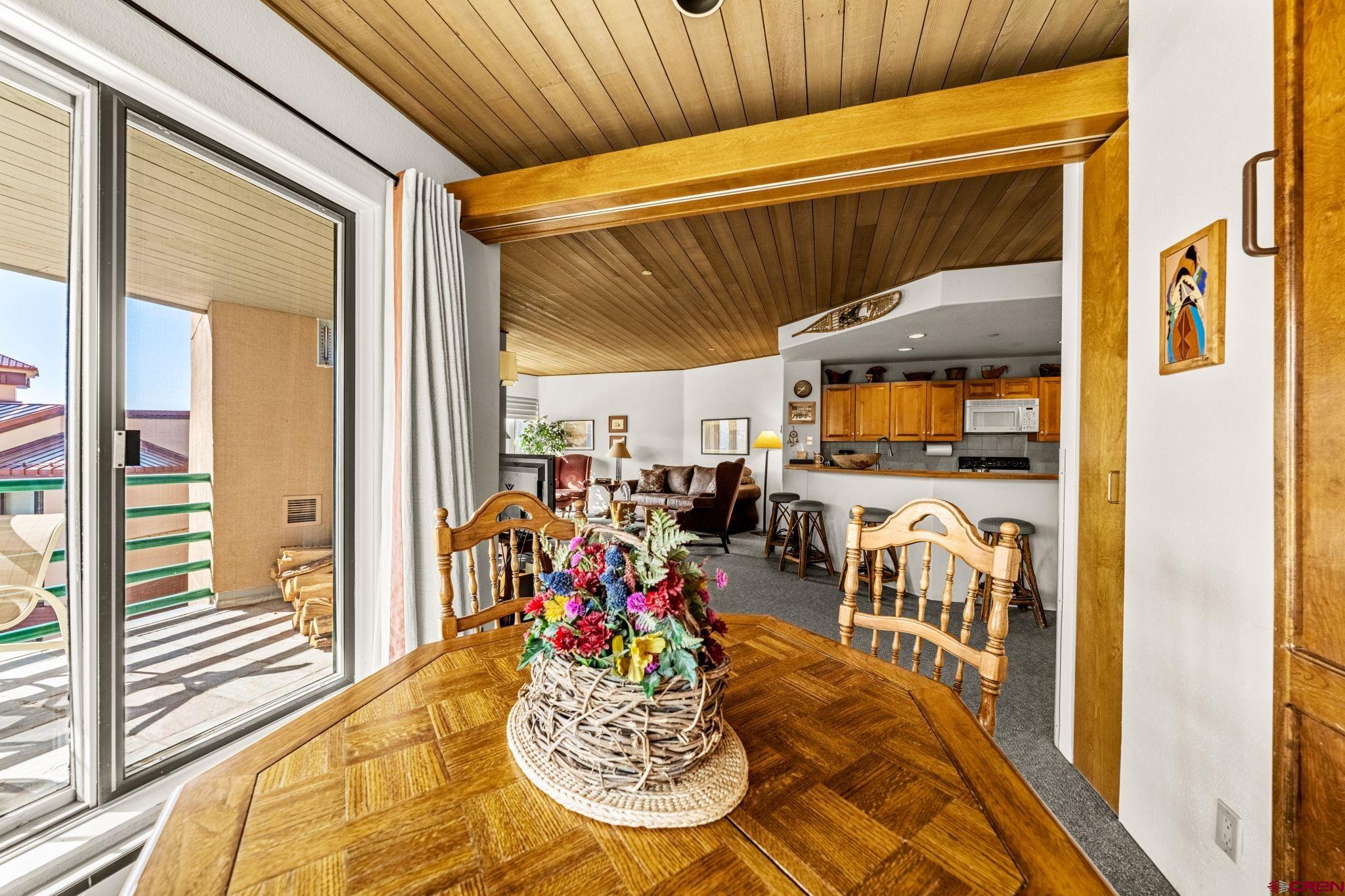117 Needles Way, Unit 528 Durango, CO 81301 - Photo 29 of 41 a view of a dining room with furniture one side kitchen view and a wooden floor