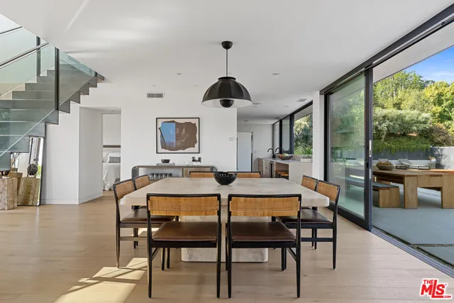 a dining room with furniture window and wooden floor