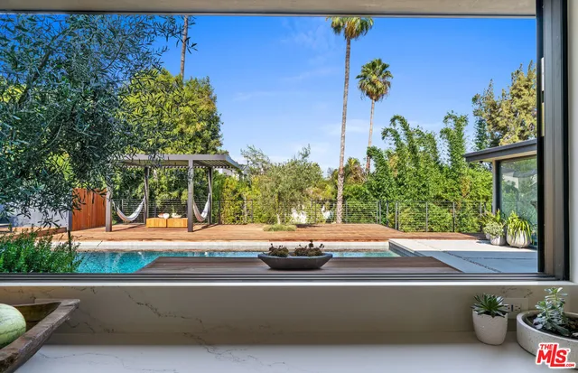 a view of a street with couches and a potted plant on the side of the road