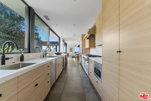 a kitchen with counter top space and stainless steel appliances