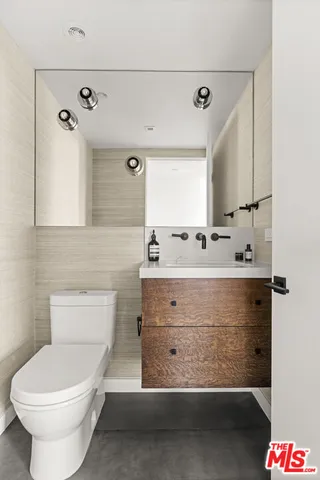 a bathroom with a sink mirror and toilet