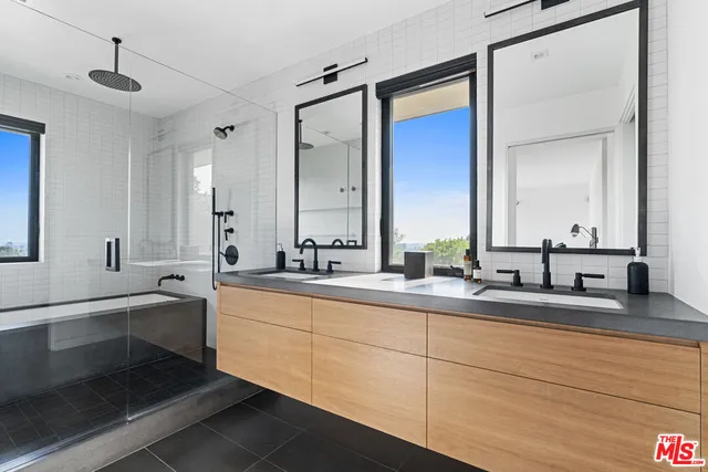 a bathroom with double vanity sinks double vanity tub and a mirror