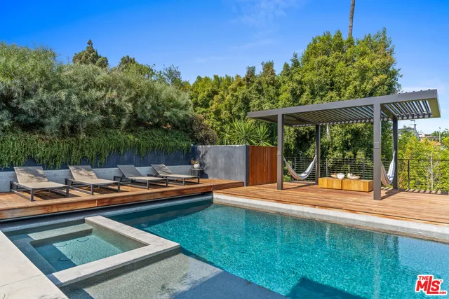 a view of a patio with swimming pool table and chairs
