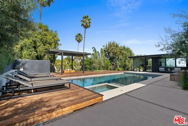 an aerial view of residential house with outdoor space and trees around