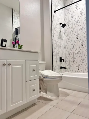 a view of a house with a yard and potted plants