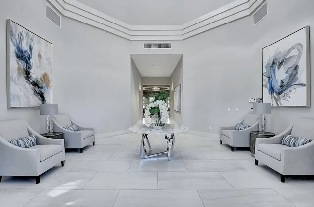 a kitchen with a table chairs and a refrigerator