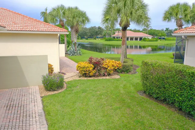 a view of a house with backyard sitting area and garden
