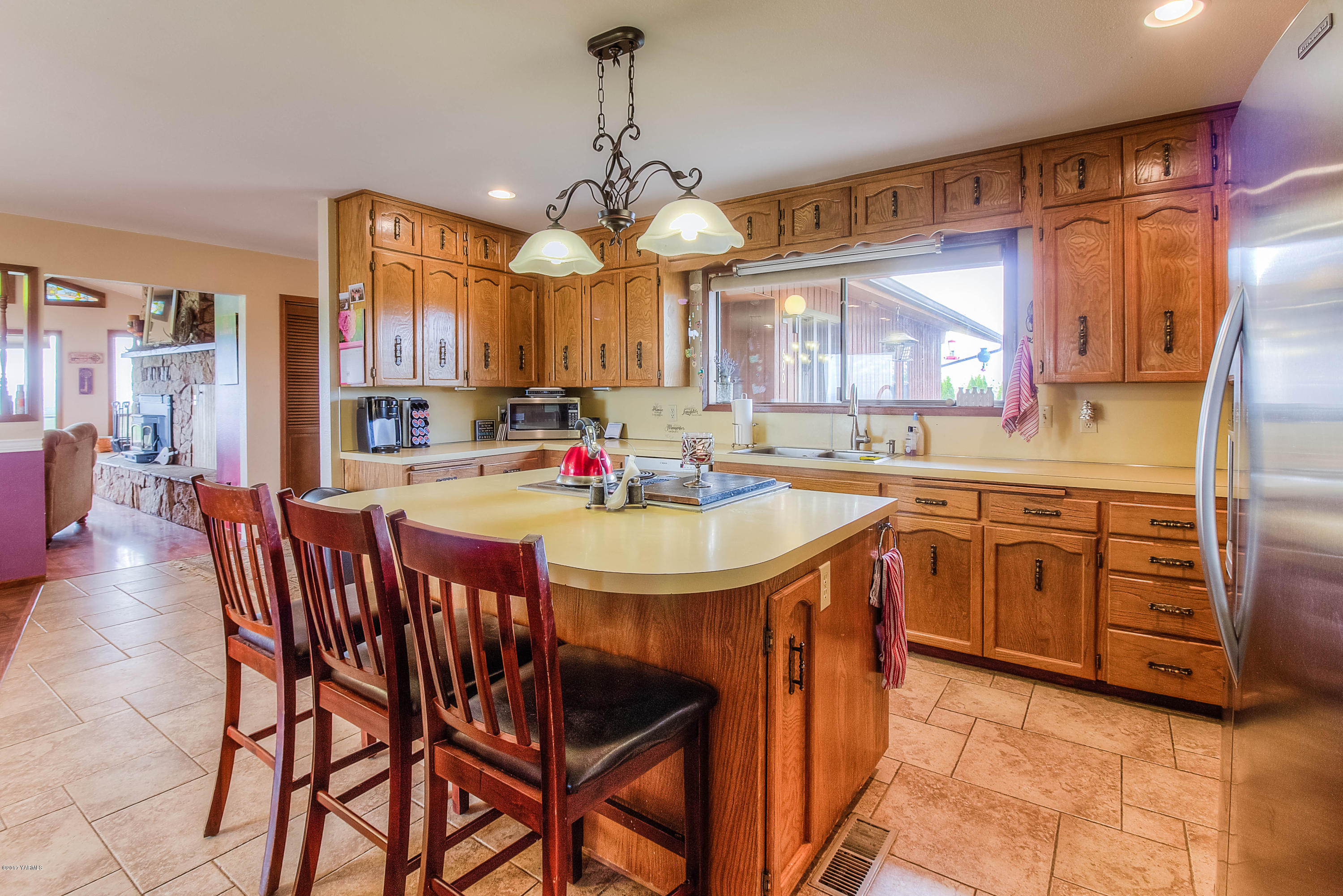 600 Cornue Road Zillah, WA 98953 - Photo 7 of 33 a kitchen with stainless steel appliances kitchen island granite countertop a sink a stove a dining table and chairs