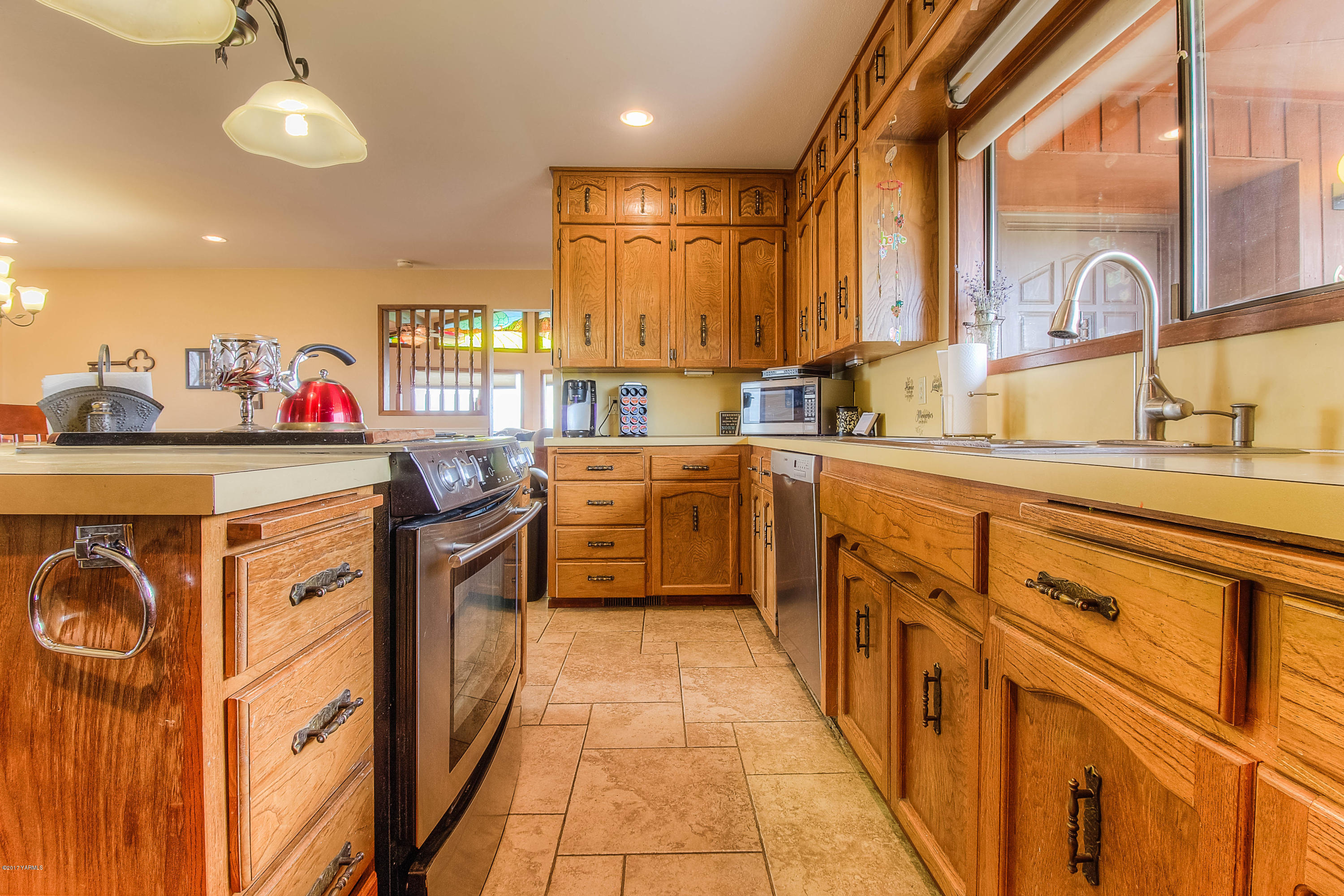 600 Cornue Road Zillah, WA 98953 - Photo 8 of 33 a kitchen with stainless steel appliances a sink stove and cabinets