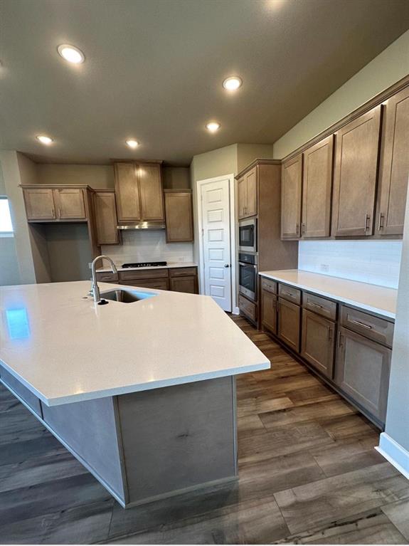 2525 Four Roses Drive Lewisville, TX 75056 - Photo 4 of 19 a large kitchen with stainless steel appliances a large counter top a stove and a refrigerator
