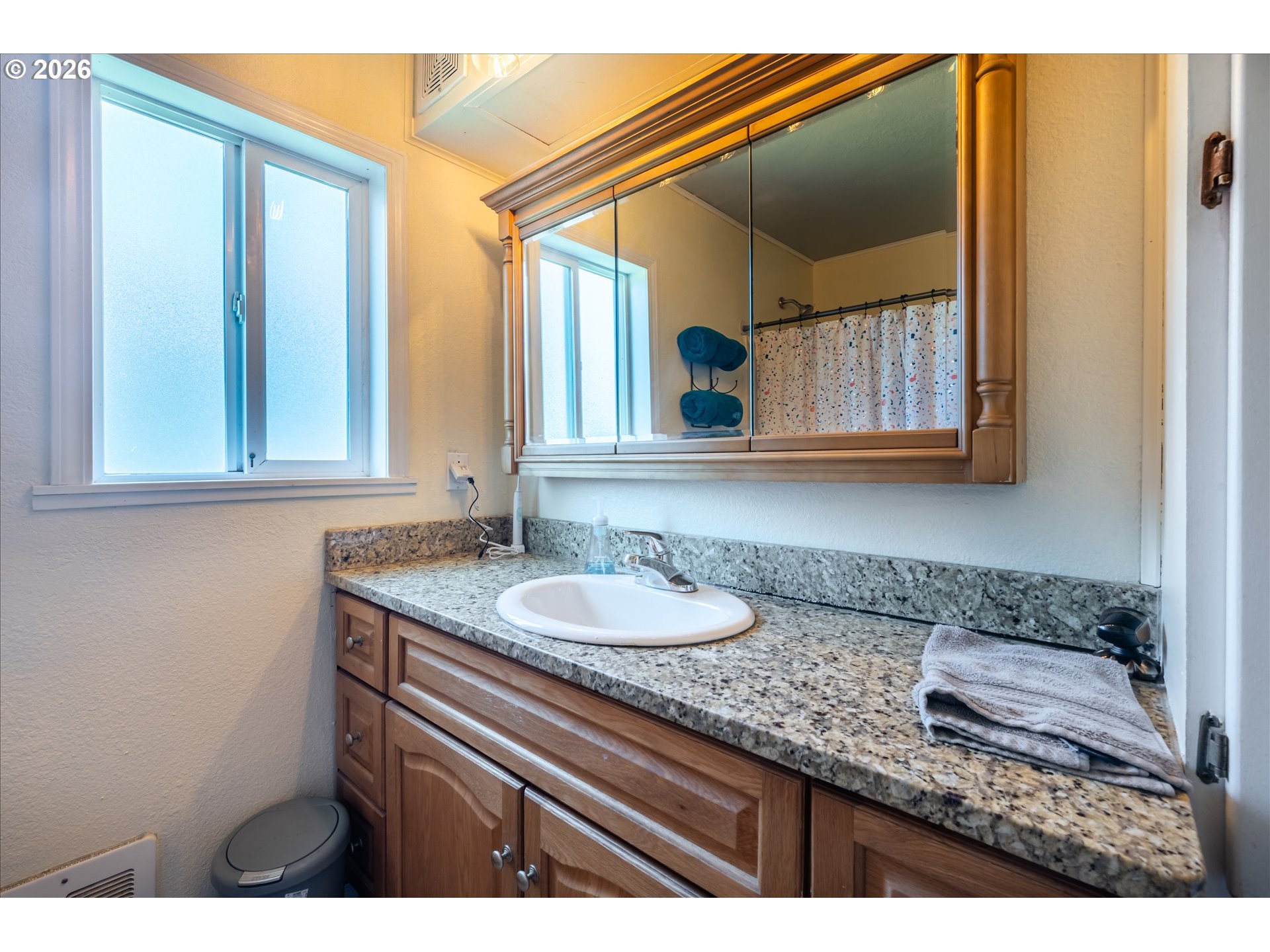 1789 14th Street North Bend, OR 97459 - Photo 31 of 43 a bathroom with a granite countertop sink and a mirror