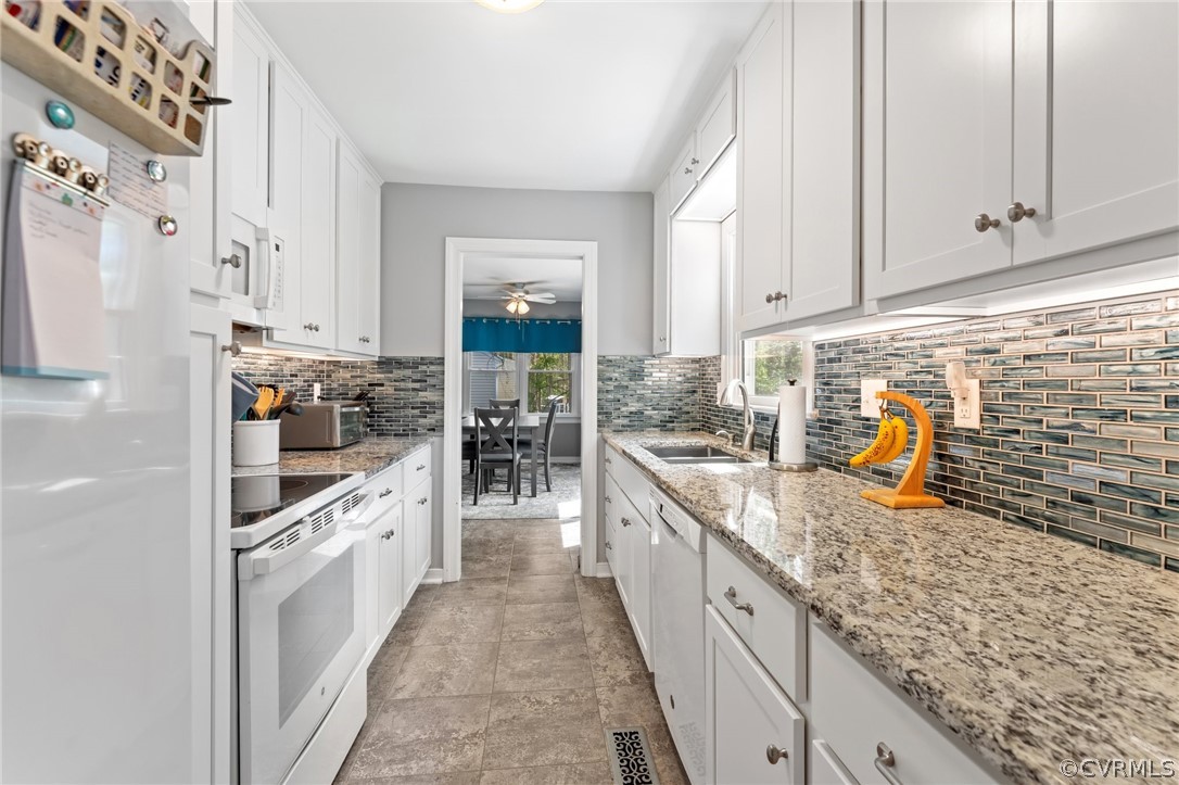 7106 Deer Thicket Drive Midlothian, VA 23112 - Photo 11 of 34 a kitchen with stainless steel appliances granite countertop a sink stove and refrigerator