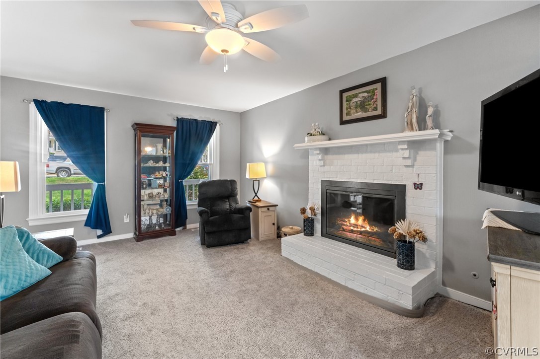 7106 Deer Thicket Drive Midlothian, VA 23112 - Photo 4 of 34 a living room with furniture a flat screen tv and a fireplace