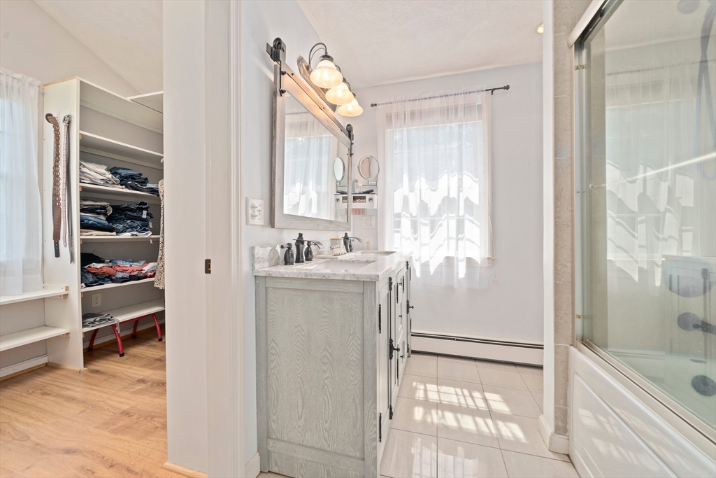 5 Kingsbury Road Canton, MA 02021 - Photo 16 of 39 a bathroom with a sink a mirror and a bathtub