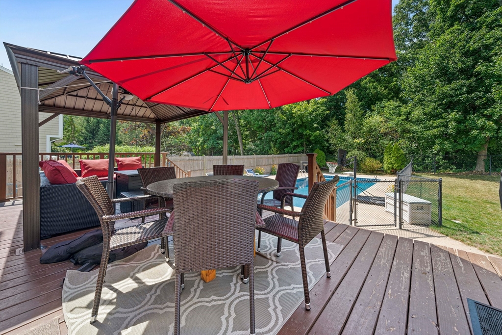 5 Kingsbury Road Canton, MA 02021 - Photo 26 of 39 a view of a deck with a table and chairs under an umbrella