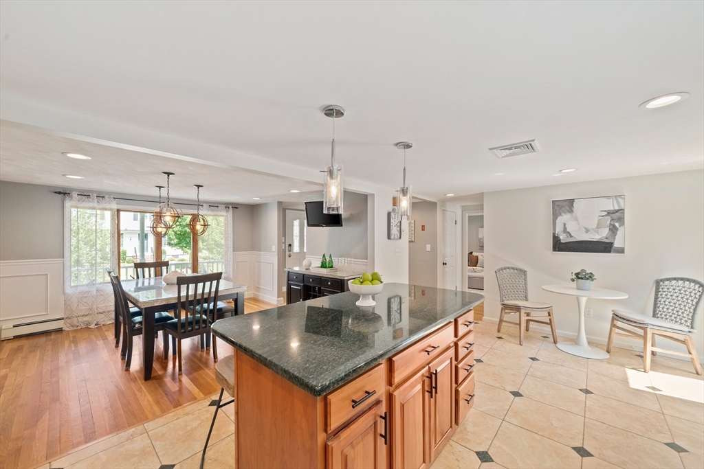 5 Kingsbury Road Canton, MA 02021 - Photo 9 of 39 a kitchen with stainless steel appliances granite countertop a table chairs and a refrigerator