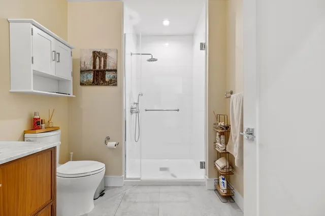 a bathroom with a toilet and a shower