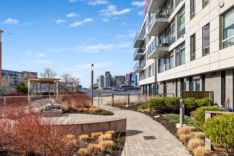 a view of a building with yard and sitting area