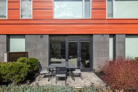a backyard of a house with table and chairs