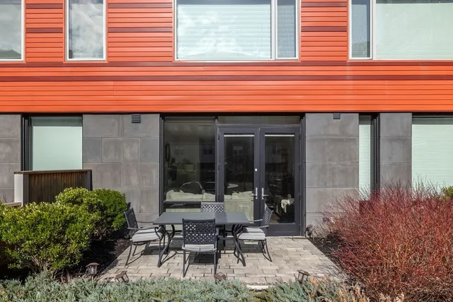 a backyard of a house with table and chairs