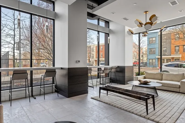 a living room with furniture and a floor to ceiling window