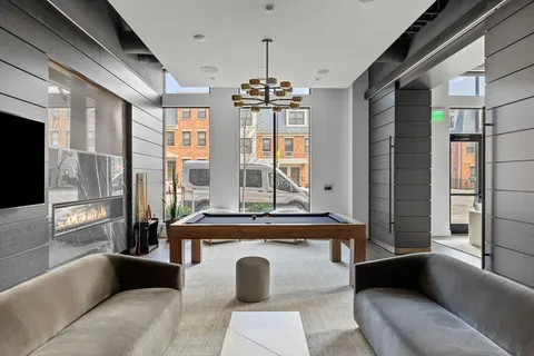 a living room with furniture and large windows