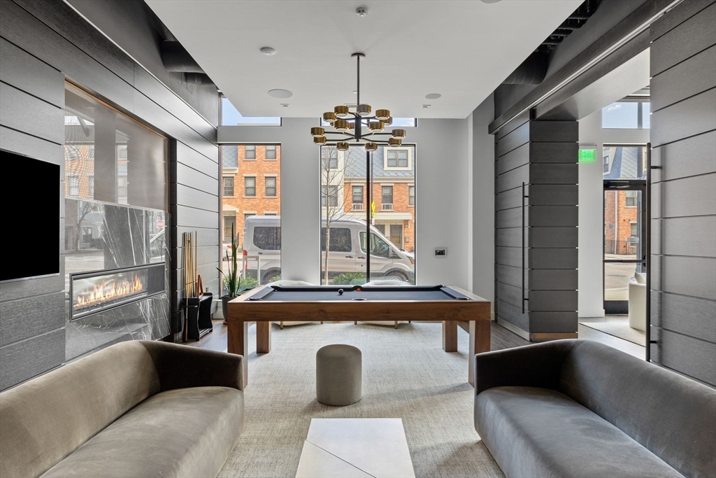 99 Sumner Street, Unit 101 Boston, MA 02128 - Photo 22 of 35 a living room with furniture and large windows