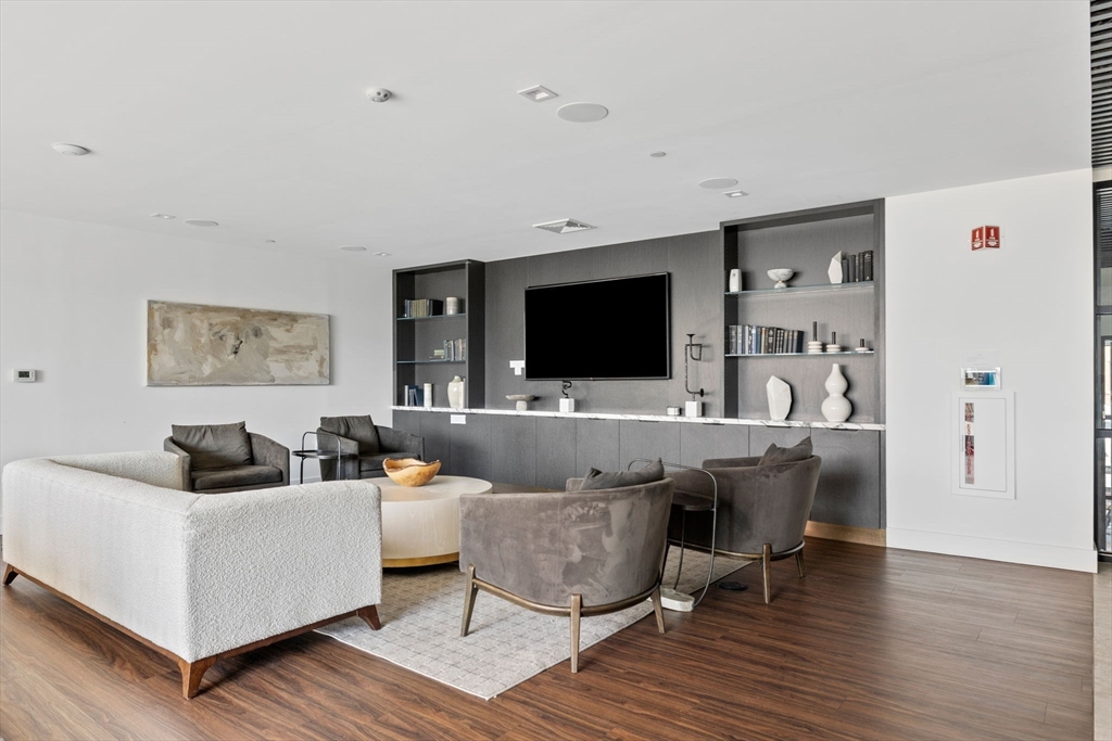 99 Sumner Street, Unit 101 Boston, MA 02128 - Photo 22 of 35 a living room with furniture and a flat screen tv