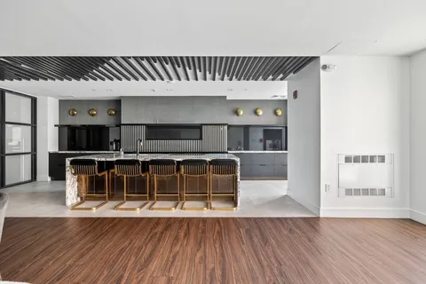 wooden floor in a hall with a large window and wooden floors