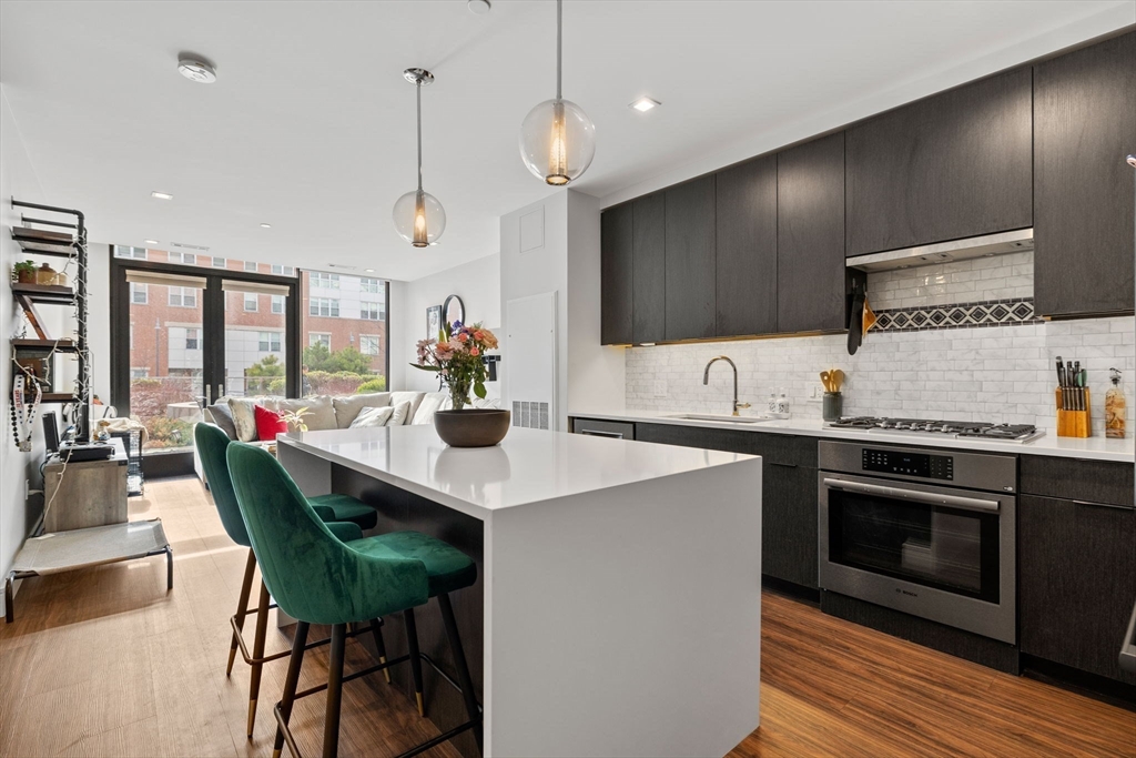 99 Sumner Street, Unit 101 Boston, MA 02128 - Photo 5 of 35 a kitchen with a table and chairs in it