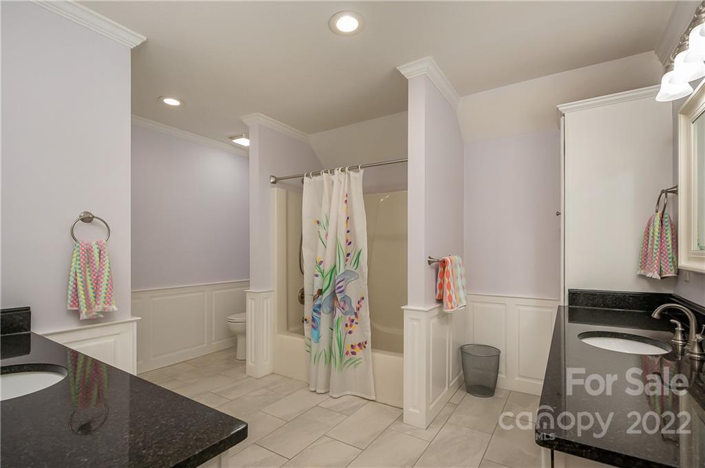 259 Bent Tree Drive Rutherfordton, NC 28139 - Photo 12 of 48 a bathroom with a granite countertop sink a mirror and shower