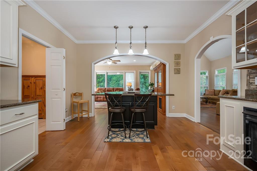 259 Bent Tree Drive Rutherfordton, NC 28139 - Photo 20 of 48 a dining room with wooden floor a chandelier a wooden table and chairs