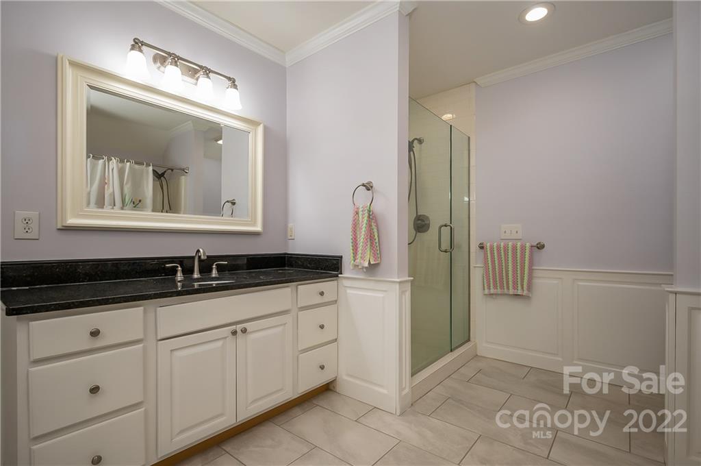 259 Bent Tree Drive Rutherfordton, NC 28139 - Photo 32 of 48 a bathroom with a granite countertop sink a mirror and a