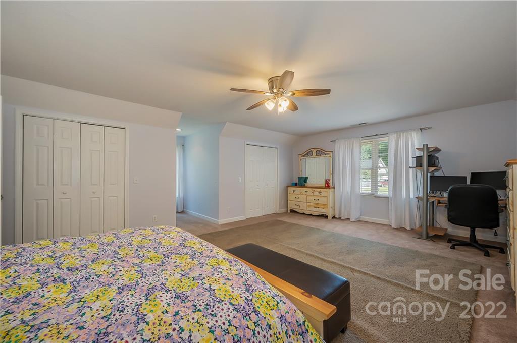 259 Bent Tree Drive Rutherfordton, NC 28139 - Photo 34 of 48 a bedroom with a bed and a chandelier