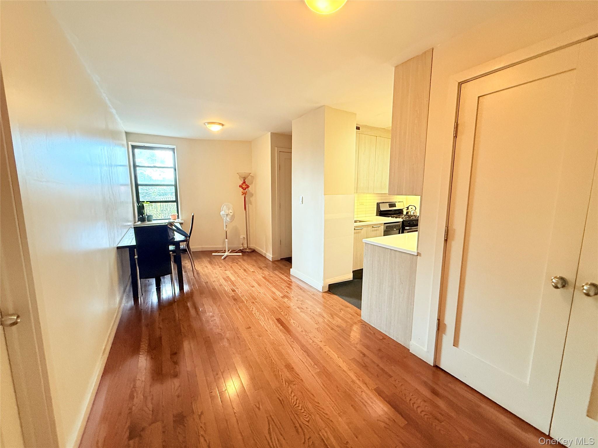 87-10 51st Avenue, Unit 5H Queens, NY 11373 - Photo 11 of 16 a living room with a wooden floor and furniture
